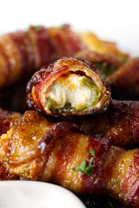 Traeger jalapeno poppers are the perfect party snack. They are stuffed with cheese, wrapped in bacon, and finished with a maple glaze. Stuffed Jalepeno, Bacon Wrapped Stuffed Jalapenos, Bacon Wrapped Figs, Wrapped Jalapeno Poppers, Bacon Jalapeno Poppers, Traeger Grill Recipes, Smoked Jalapeno, Bacon Wrapped Jalapeno Poppers, Bacon Wrapped Jalapenos