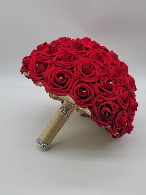 Each bouquet is handmade to order using real touch roses. A rhinestone is placed in the center of every rose. Handle is made up of your choice of satin ribbon and handle accessories: Brooch: Silver, Gold, Or Rose Gold Bling wrap: Silver, Gold, Rose Gold, No accessories Bouquets are available in 4 sizes: 6 inch 8 inch 10 inch-Pictured in listing 12 inch Matching Boutonnieres and corsages available in listing below...Or see store for all styles of boutonnieres and corsages you can customize to you Red Rose Bridal Bouquet, Gold Wedding Bouquets, Ivory Bridal Bouquet, Ivory Bouquet Wedding, Red Bridal Bouquet, Toss Bouquet, Gold Bouquet, Bridal Brooch Bouquet, Bridesmaids Bouquet