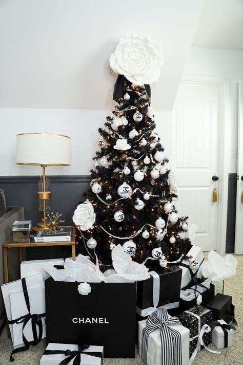 This DIY Chanel themed Christmas tree I made for my den is the ultimate girly glam tree I never knew I needed. Complete with the classic black and white color scheme, Chanel logo ornaments, white pearls, and Camellia flowers, it's my favorite tree in my house. Click thru to see how I made it, and check out my other 4 trees Black And White Chanel Christmas Tree, Chanel Inspired Christmas Decor, Chanel Theme Christmas Tree, Channel Christmas Tree, Chanel Inspired Christmas Tree, Coco Chanel Christmas Tree, Chanel Tree Christmas, Chanel Christmas Tree Ideas, Chanel Christmas Tree