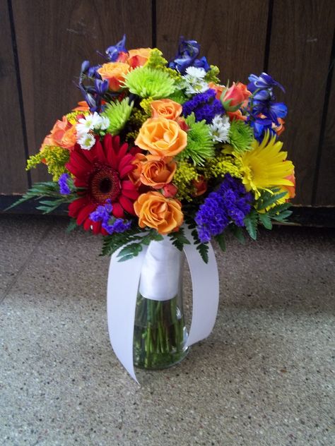 Bridal Bouquet - Bright colorful mix with orange spray roses, green mums, yellow and red gerber daisies, blue delphinium and statice. Bridal Bouquet Bright, Colorful Bridal Bouquet, Blue Delphinium, Gerber Daisies, Yellow Wedding, Spray Roses, Something Old, Delphinium, Brides And Bridesmaids