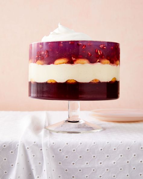 Pomegranate-Coconut Trifle | Velvety coconut custard is sandwiched between two gelatins in this magnificent make-ahead dessert: pomegranate on the bottom and coconut water (studded with pomegranate seeds) on the top. Store-bought lady fingers keep each layer separate, and the whole thing is finished with whipped cream and toasted coconut.    #food #recipe #marthastewart #baking #dessertrecipes Jello Ideas Desserts, Coconut Trifle, Jello Ideas, Christmas Trifle Recipes, Easy Scone, Vegetable Planting Calendar, Cream Pie Filling, Fruit Trifle, Jello Salads