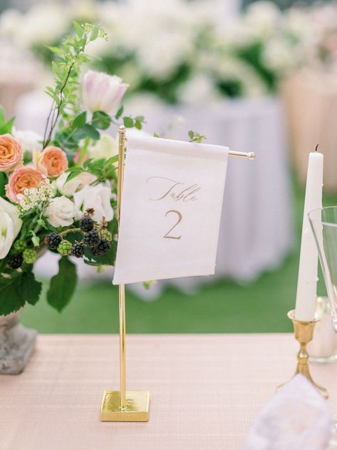 Small angled fabric table number on a tall gold Style Me Pretty stand. Off-white fabric with gold ink featuring elegant script and a modern block font table number for the Merrimon-Wynne House Winter Bridal Showcase in Raleigh, North Carolina. Photo by Alaina Ronquillo Photography. Fabric Table Numbers Wedding, Flag Table Numbers, Tall Table Numbers Wedding, Classy Table Numbers, Garden Party Table Numbers, Fabric Table Numbers, Linen Table Numbers, Wedding Stationery Checklist, Table Number Ideas