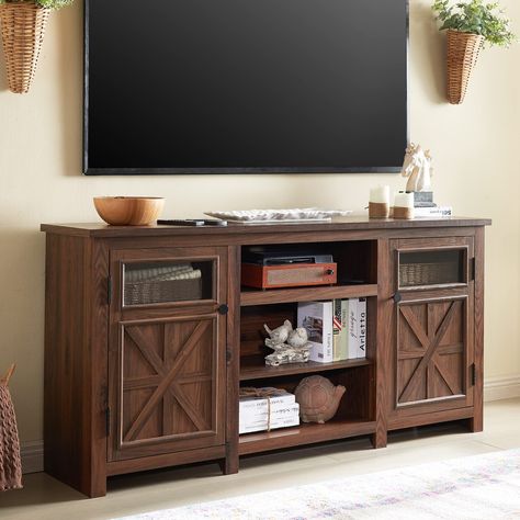 PRICES MAY VARY. FARMHOUSE STYLE TV STAND: Our 66-inch TV stand is designed in a style that blends farmhouse elements with a modern look, using a combination of vintage traditional flush doors and modern clear glass decor, with an overall structure of sleek lines for a beautifully atmospheric look. Smooth lines and a neutral colour scheme add a stylish touch to the rustic farmhouse. SPACIOUS TABLETOP: Measuring a 66"*16" roomy tabletop suitable for up to 75 inch television. There's plenty of room for family photos, potted plants and other decorations without being cramped. With a 1.18" thickened desktop that can hold 150 pounds and an overall use of premium engineered wood, this TV Console can withstand the challenges of long-term use. HUGE STORAGE SPACE: The overall 66"W x 16"D x 26"H hug 75 Inch Tv, Rustic Tv Console, Entertainment Center With Storage, Credenza Wood, Farmhouse Tv, Modern Tv Cabinet, Tv Stand Decor, Modern Entertainment Center, Farmhouse Tv Stand