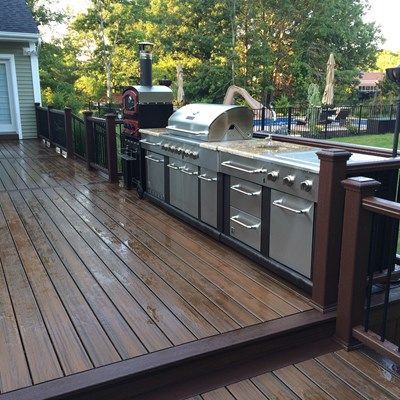 This backyard project includes a multilevel Trex Deck with cooking area leading down to a Cambridge stone patio Backyard Grilling Area, Backyard Patio Deck, Diy Backyard Patio, Patio Deck Designs, Deck Designs Backyard, Pergola Design, Trex Deck, Patio Kitchen, Backyard Kitchen