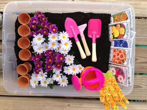 Made a gardening sensory bin for Chloe! Potting soil, seed packages, Mini pots, tools, gloves, watering can and fake flowers! Spring Garden Sensory Bin, Flower Garden Sensory Bin, Soil Sensory Bin, Seed Sensory Bin, Gardening Sensory Bin, Flower Sensory Bin, Flower Sensory, Garden Sensory Bin, Spring Sensory Bin