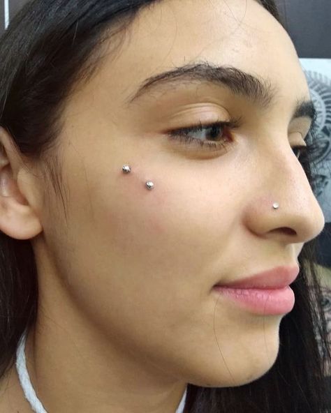 Piercing On Cheekbone, Surface Face Piercing, Side Of Face Piercing, Crowded Face Piercings, Upper Cheek Piercing, Face Peicerings, Face Dermal Piercing Cheek, Piercing Face Ideas, Cute Peicerings Face