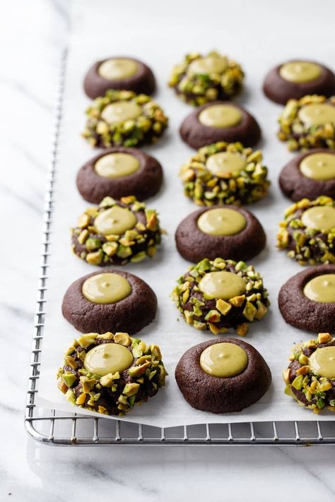 Best Things To Cook December 2022 Bakery Style Baked Goods, Chocolate Pistachio Thumbprint Cookies, Cute Chocolate Desserts, Recipes Using Pistachio Cream, Pistachio Christmas Cookies, Recipes With Pistachio Cream, Pistachio Butter Dessert, Pistachio Sweets, Pistachio Thumbprint Cookies Recipe