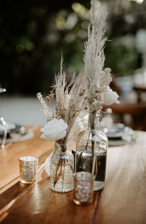 cristal bottles with dry leaves, dry flowers and roses with gold votives with led candles wooden round table Gold Votives, Centerpiece For Wedding, Dry Leaves, Tulum Wedding, Dry Flowers, Dry Leaf, Led Candles, Round Table, Wedding Theme