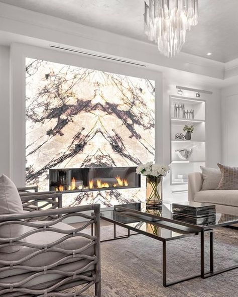 Book Matched Marble Fireplace, Marble Wall In Living Room, Marble Wall With Fireplace, Marble Walls Living Room, Living Room With Marble Fireplace, Backlit Marble Wall, Backlit Stone Wall, Marble Feature Wall Living Room, Backlit Fireplace