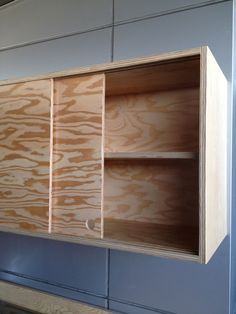 Sliding cabinet doors and discreet handles keep the piece looking sleek. Kitchen Cabinets Sliding Doors, Sliding Cabinet Doors, Diy Cabinet Doors, Plywood Kitchen, Plywood Cabinets, Diy Drawers, Diy Garage Storage, Cabinets Diy, Diy Valentine