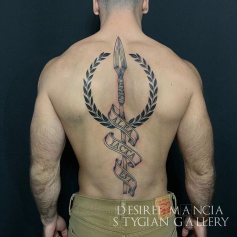 spear and laurel wreath tattoo with latin script done at Stygian Gallery, Atlanta Conqueror Tattoo Ideas, Spear Tattoos, Spear Of Leonidas Tattoo, Spear Of Destiny Tattoo, Spear And Shield Tattoo, Spear Tattoo Men, Spear Tattoo Design, Spartan Chest Tattoo, Roman Spear Tattoo