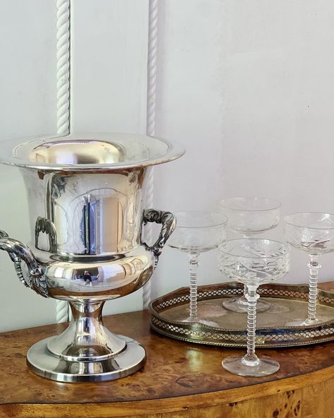 We are always party ready here at House of Modern Vintage so stock up on the champagne because we re-stocked our Party & Holiday Collection. Vintage silver champagne bucket & etched champagne coupes. And if you don’t have any champagne, fill with flowers! #traditionalhome #mytraditionalhome #southernhome #neworleansvintage #vintagehomedecor #interiorstyling #grandmillenialhome #neworleanshome #antiquedecor #antiqueshop #neworleansantique #myhousebeautiful #homefurnishings #furniture #vinta... Bucket With Flowers, Modern Vintage Home Decor, Champagne Bucket, Vintage Champagne, Champagne Buckets, Outdoor Furniture Collections, Southern Home, Champagne Bottles, Vintage Cocktail