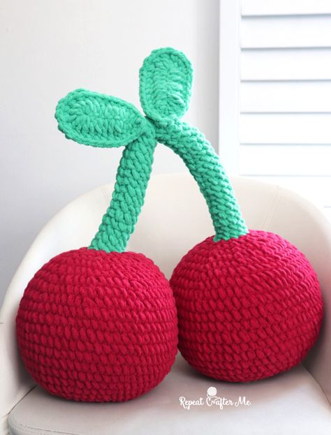 A pair of cherries that are big enough and plush enough to be an accent pillow! Great decor for a dorm room, kids bedroom, or an arm chair. Grab that Bernat Blanket Brights yarn in colors Race Car Red and Go Go Green! This pattern works up quickly with a size J hook. Together they … Red Crochet Ideas, Bernat Super Value Yarn, Crochet Gingerbread, Cow Hat, Granny Stripe, Stripe Crochet, Repeat Crafter Me, Crochet Fruit, Crochet Snowman