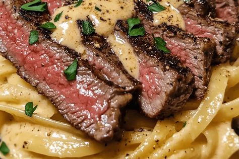 Try this Creamy Cajun Steak Alfredo! Tender steak, fettuccine, and a spicy Alfredo sauce make for a rich, flavorful, easy dinner in 35 min. Spicy Cajun Steak With Creamy Alfredo, Creamy Steak Fettuccine Delish, Steak And Fettuccine, Cajun Steak And Shrimp Alfredo Pasta, Spicy Cajun Steak Alfredo Pasta, Cajun Steak Pasta Recipes, Steak Shrimp Alfredo Pasta, Creamy Cajun Steak Pasta, Cajun Shrimp & Steak Alfredo Pasta