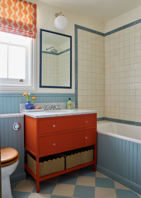 Family Home N7 - Laura Stephens Blue Bathroom Suite, Orange Bathroom Cabinets, Tremont Home, Primary Color Bathroom, Navy Cabinets Bathroom, Blue And Red Bathroom, Colorful Lake House, Budget Bathroom Makeovers, Toddler Bathroom Ideas