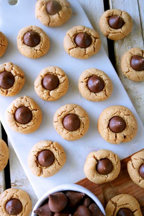 The best recipe for bite-sized, soft peanut butter kiss cookies, also known as peanut butter blossoms. The perfect cookie-to-kiss ratio! #theanthonykitchen #partyfood #comfortfood #easyrecipes #homemaderecipes #fromscratch #familymeals #southernfood #foodforentertaining #recipesforentertaining #comfortfood #easycomfortfood Thumbprint Cookies Hershey Kiss, Peanut Butter Kiss Cookies Recipe, Easy Baking For Kids, Kiss Cookie, Kiss Cookie Recipe, Hershey Kiss Cookies, Chocolate Drop Cookies, Peanut Butter Kiss, Homemade Peanut Butter Cookies