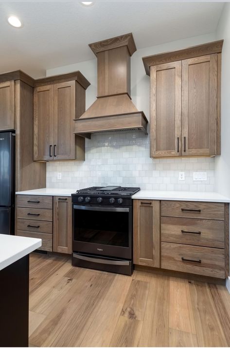 Grey Floor Brown Cabinets, Light Wood Cabinets With Black Appliances, White And Brown Wood Kitchen, Furniture List For New House, Stain Grade Kitchen Cabinets, Backsplash With Light Brown Cabinets, Black Island With Wood Cabinets, Wood Cabinet Backsplash, Wood Cabinets With Black Appliances