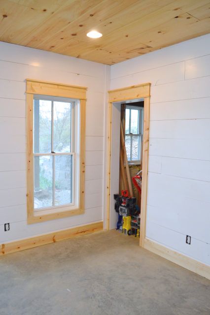 installing DIY shiplap walls and farmhouse trim from wood flooring Simple Wood Window Trim, Farmhouse Living Room Trim, Farmhouse Molding And Trim Wood, Window Trim No Sill, Simple Farmhouse Trim, Modern Farmhouse Interior Trim, Tall Baseboard Trim, Farmhouse Chair Rail, Natural Wood Window Trim