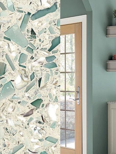 Emerald Coast was inspired by the glassy green sea of the South's Emerald Coast. The surface is crafted from Georgia marble, South Carolina oyster shells and demolition architectural glass. We think the emerald and lighter aqua greens match perfectly with the blue-green hue of In The Moment. When paired with white and light natural wood, the color comes off as energetic and vibrant. Beach House Paint Colors, Behr Color Trends, Coastal Style Bathroom, Modern Coastal Design, House Paint Colors, Coast Kitchen, Recycled Glass Countertops, Glass Countertop, Cool Calm And Collected