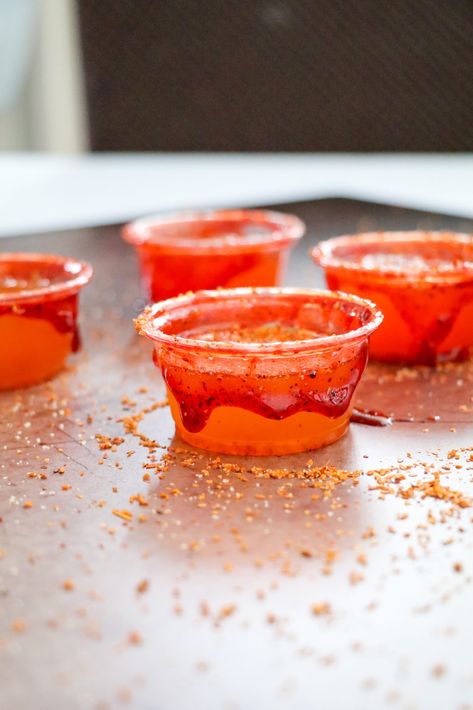 Chamoy Mexican Candy Jello Shots Smirnoff Tamarindo Jello Shots, Candy Shots Alcohol, Mangonada Shots, Tajin Jello Shots, Spicy Tamarind Vodka Jello Shots, Mexican Lollipop Shot Recipe, Chamoy Jello Shots, Mexican Candy Shot Recipes, Mexican Candy Jello Shot Recipes