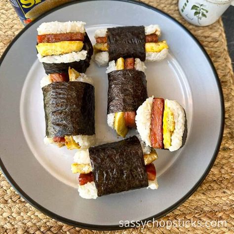 Spam Musubi is a delicious Hawaiian snack that combines the sweetness of sushi rice and the savory umami of Spam. But do you know that you can elevate it to a whole new level of deliciousness by adding perfectly cooked eggs? In this blog post, I'll walk you through a step-by-step guide on how to make Spam musubi with egg and much more. Read on!  What is Spam musubi with egg?This popular Hawaiian snack combines elements of sushi and American comfort food, and it is a variation of the… Easy Spam Musubi, Spam Sushi, Hawaiian Snacks, Five Spice Chicken, Rice In The Microwave, American Comfort Food, Lemon Drop Cookies, Drop Cookie Recipes, Spam Musubi