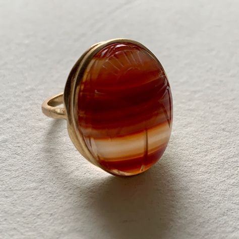 Gorgeous Egyptian Revival Ring In 14k Gold With A Beautiful Banded Agate Specimen Carved With A Traditional Scarab Motif. The Translucent Bands Make This A Very Ethereal Piece. If You Are A Vintage Or Antique Jewelry Collector, This Is For You. In Amazing, Seemingly Unused Condition. Pictures Do Not Do Justice To The Beautiful Carved Details. 6.8 Grams. Size 7. Band Marked 14k Aa. Back Of Agate Cabochon Also Carved With A Inside A Carved Geometric Shape. Scarab Egyptian, Vintage Jewelry Antique, Antique Jewelry Rings, Egyptian Revival, Agate Cabochon, Ring Crafts, Banded Agate, September 2024, Womens Jewelry Rings