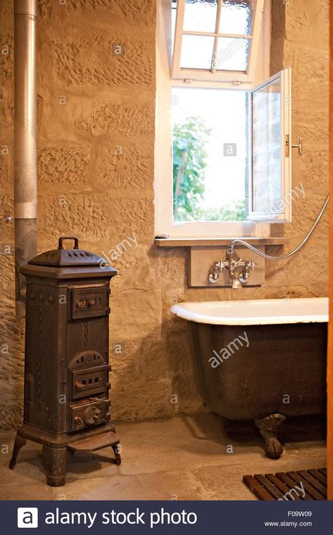 Download this stock image: Old fashioned bathroom with, stove, sink and bathtub - F09W09 from Alamy's library of millions of high resolution stock photos, illustrations and vectors. Small Bathroom Classic, Old Fashioned Bathroom, Bathroom Wood, Ranch Ideas, Rustic Shower, Cabin Bathroom, Cabin Bathrooms, Wood Bathroom, In Bathroom