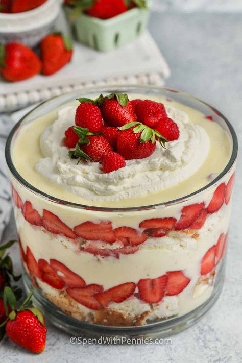 A layered trifle is so easy to make. Guests will gush over the impressive presentation of this fresh & fruity dessert. Sweet white cake, custard or vanilla pudding, and strawberries topped off with whipped cream. It's a summer favorite! #trifle #triflerecipe #easytrifle #spendwithpennies Cream Cheese Strawberry Shortcake, Fruit Trifle Recipes Custard, Strawberry Trifle With Pudding, Trifle With Vanilla Wafers, Strawberry Shortcake With Vanilla Pudding, Strawberries And Cream Trifle, Vanilla Cake Trifle, Strawberry Shortcake Trifle Easy, Truffle Desserts Layered Easy