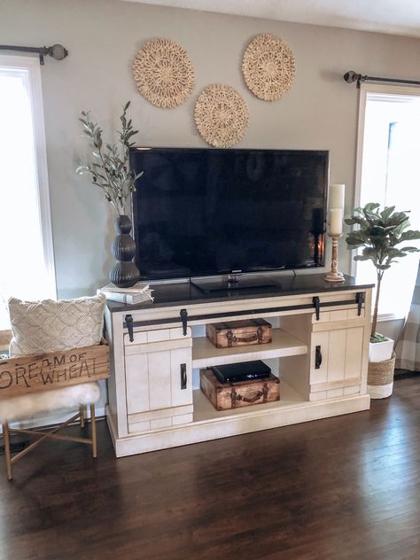 Farmhouse Living Room Above Tv, Above Living Room Tv Decor, On Top Of Tv Wall Decor, Decorate Around Tv Stand Living Rooms, Decorating Above Tv Stand, Boho Farmhouse Tv Stand Decor, Decor Around Tv On Wall Boho, Above Tv Wall Decor Bedroom, Western Tv Stand Decor