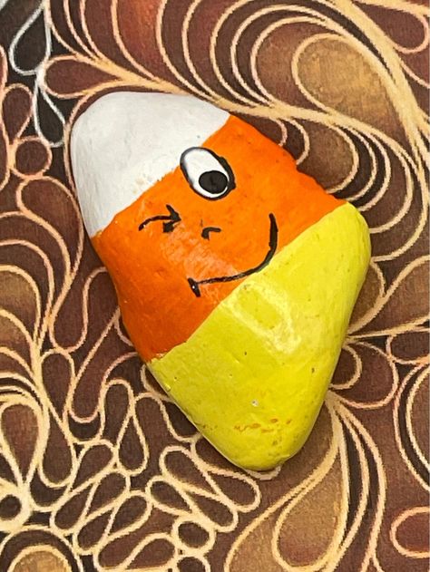 "Cartoon Face Winking Candy Corn, Hand Painted Rock Measures approximately:  Height 2\" Length 1.25\" Depth .5\" ✽ My painted rocks are natural creek rocks collected locally in middle Tennessee and hand painted by me.  ✽ Your stones are handpicked and hand painted by me with love! Each is a one-of-a-kind piece of art! I hope they bring much joy, happiness, and a smile to you.   ✽ These are natural creek rocks so each stone is unique and no two rocks are identical.  The size, shape, and texture may vary slightly. ✽ Each stone design is drawn by hand, painted with acrylic paints, sealed, and packaged with care to send to your home from my home in middle Tennessee.   ✽ All my creations are sealed to protect and preserve the quality. ✽ Want a custom design?  If you don't find exactly what you' Fall Painted Rocks, Halloween Painted Rocks, Rock Cactus, Fall Rock, Halloween Kunst, Diy Rock Art, Cartoon Face, Halloween Rocks, Seashell Painting