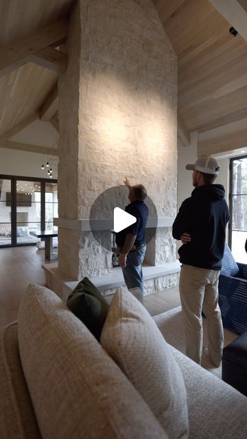 Hendel Homes on Instagram: "Talking with one of our knowledgeable site supervisors on the background behind this custom designed fireplace. Walking into the great room, this feature certainly draws your eye in as you step into the space. Properly executed with quality by @lukebuskermasonry @orijinstone and @glowing_hearth. A limestone feature we love that compliments both the exterior and interior!" Fireplace Bench Ideas, Indoor Stone Fireplace, Limestone Fireplace Wall, Stone Fireplaces Floor To Ceiling, Fireplace In The Middle Of The Room, Fireplace In Middle Of Room, Fireplace Build Out, Limestone Wall Interior, Rock Fireplace Ideas