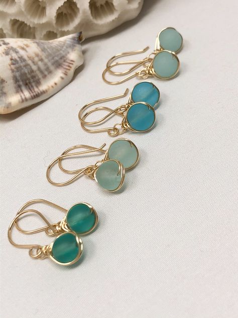 A minimal yet luxurious design featuring beautiful, cultured sea glass. These colors are so gorgeous and translucent they look like they glow from within! These cultured sea glass beads are 6mm in size Each shade of blue is reminiscent of the crystal blue waters in exotic regions of the world. The design is kept subtle with a dainty herringbone wrap and a finished with a hand-forged French ear wire. #christmasgiftideas #christmasgiftforher #giftsforher Foam Earrings, Sea Glass Beads, Beachglass Jewelry, Sea Glass Earrings, Wrap Jewelry, Diy Wire Jewelry, Wire Work Jewelry, Jewellery Ideas, Handmade Wire Jewelry