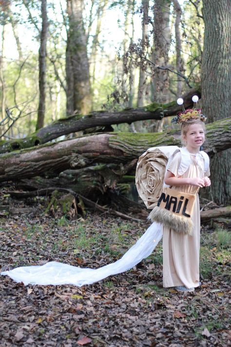 Snail who brings the mail. Diy Light up eyes, light up slime train. Crown made from dried flowers, ping pong balls, and pumpkin stems. Train made from plastic and lights. Shell made from cardboard and packing paper. Neutral tones. Family Halloween Costume ideas. #familyhalloweencostumes #snailmail #gnome #mushroom #costume #costumes #mommyandme #daddydaughter #family #snail #snailcostume Snail And Mushroom Costume, Snail Mail Costume, Snail Costume Women, Snail Costume Diy, Diy Snail Costume, Mushroom Costume Diy, Mushroom Costume Women, Snail Costume, Family Halloween Costume Ideas