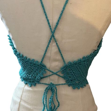 Hand Crocheted Halter Top Turquoise Size S/M Add a unique touch to your wardrobe with this hand crocheted halter top in a beautiful shade of turquoise. The top features spaghetti straps and a tie closure, making it adjustable and perfect for any casual occasion. The fabric type is crochet and the material is acrylic, making it a comfortable choice for summer and spring. The sleeveless design and regular fit make it an ideal choice for women who love hippie-themed clothing. It is a han... Crochet Halter, Crochet Halter Tops, Shades Of Turquoise, Hand Crochet, Halter Top, Spaghetti Strap, Spaghetti, Shades, Turquoise