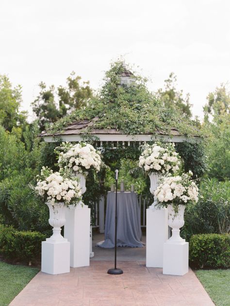 Photography: esther sun photography - esthersunphoto.com Tres Chic Affairs. white, grey greenery wedding. olive branches. ceremony decor. pillars. urns. All White Flowers, Gardenia Wedding, Wedding Pillars, Sun Photography, Church Wedding Decorations, Mountain Ranch, Olive Branches, Wedding Altars, Wedding Ceremony Flowers