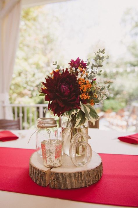 Mason Jar, Votive Candle, Wooden Stump, Red Centerpiece for Wedding Reception    Charming Red Wedding - Southern Outdoor Garden Wedding - CJ's Off the Square in Franklin, TN Red Mason Jar Centerpieces, Red Fall Wedding Centerpieces, Mason Jar Fall Wedding Centerpieces, Simple Fall Wedding Decorations Centerpiece Ideas, Burgundy And Rust Wedding Centerpieces, Simple Fall Centerpieces For Table Wedding, Simple Fall Flower Centerpieces, Rustic Red Wedding Decor, Rustic Fall Centerpieces Wedding