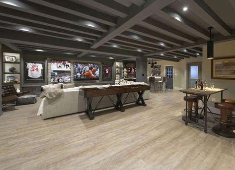 Sports Den | Basement Ideas (Photo: Bob Narod Photography; Design: Metro Building and Remodeling) #finishedbasementideas Transitional Basement, Exposed Wood Ceilings, Industrial Basement, Tv Rooms, Dark Basement, Dream Basement, Cozy Basement, Diy Basement, Building Remodeling