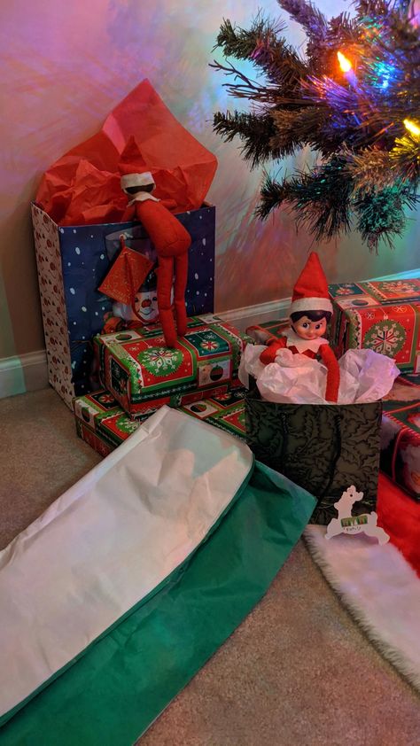 Elf on the shelf. Jingle is peeking in the presents while Snowflake wraps a family gift. Gifts Elf On The Shelf Can Bring, Elf On The Shelf Presents Gift Ideas, Birthday Traditions, Smiles And Laughs, Shelf Ideas, Present Gift, On The Shelf, Christmas Magic, Family Gifts