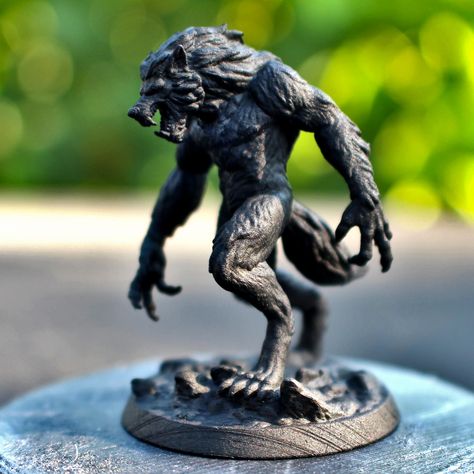 A black werewolf miniature for tabletop roleplaying games like dungeons and dragons or pathfinder.  The figure is outside on a black pedestal with blurry green leaves in the background. Werewolf Miniature, Dnd Mini, Miniature Photography, Assassin Creed, Ive Got This, Pathfinder Rpg, Dungeon Master, Assassins Creed, Tabletop Games