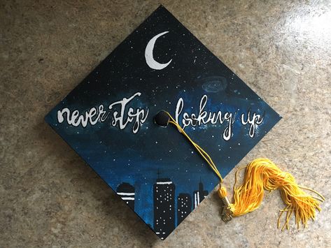 Graduation Cap #City #Stars New adventures #moon Never stop looking up Sun And Moon Graduation Cap, Space Graduation Cap, Moon Graduation Cap, Stars Graduation Cap, Star Graduation Cap, Space Theme Decorations, High School Graduation Cap Designs, Msw Graduation, Disney Graduation Cap