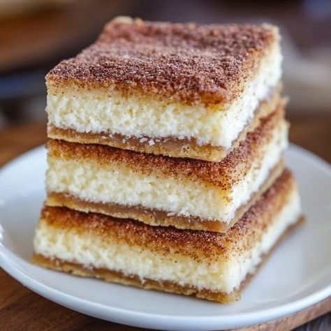 Super Easy Churro Cheesecake Bars Recipe Churros Cheesecake Bars, Dessert For Taco Bar Party, Mexican Birthday Dessert, Mexican Potluck Ideas Desserts, Dessert With Mexican Food, Churro Dessert Ideas, Easy Mexican Dessert, Taco Night Dessert, Churros Cake