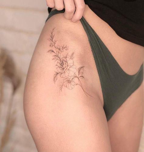 Tattoo Side Thigh Hip, Under Hip Tattoo, Foliage Hip Tattoo, Thigh Tattoos Small Simple, Fine Line Flower Tattoo Thigh, Hip Flowers Tattoo, Easy Does It Tattoo, Lilac Hip Tattoo, Dainty Flower Hip Tattoo