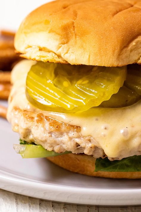 These delicious chicken smash burgers are a fun twist on the classic smash burger. I add lots of caramelized onions and cheddar to my version! crunchtimekitchen.com #chicken #smashburgers Chicken Smash Burger, Juicy Lucy Burger, Ground Chicken Burgers, Butter Burgers, Sour Pickles, Smash Burgers, Lean Chicken, Burger Toppings, Chicken Patties