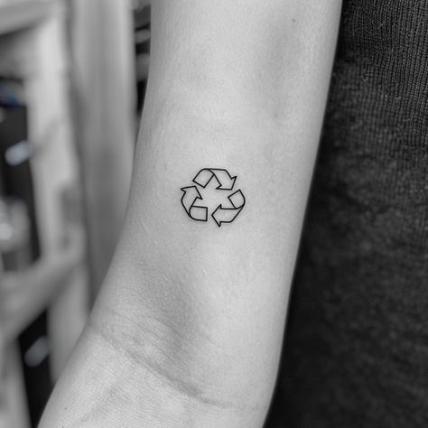 Embrace sustainability with a minimalist tattoo that makes a bold statement. This striking black ink symbol on the forearm, representing recycling, invites us all to commit to a greener planet. Let this be a reminder that every small action counts. Save for eco-inspiration and follow for more ways to live sustainably. #EcoTattoo #Sustainability #RecycleSymbol #MinimalistInk #GreenLiving #SaveThePlanet #EcoFriendly #AIimage Save The Planet Tattoo, Climate Tattoo, Environmentalist Tattoo, Sustainable Tattoo, Environment Tattoo, Recycle Tattoo, Earth Tattoo, Live Sustainably, Recycle Logo