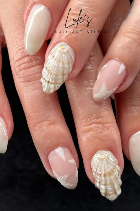 The nails by @lules_nail_art_studio showcase shells in broken white and light brown hues, enhanced by a clear 3D effect that gives them a realistic appearance. Adding to the beachy charm are delicate starfish nail art designs, completing the coastal-inspired look with a touch of whimsy. Dive into 25 stunning ocean nail ideas on Nailustrous and get inspired for your next seaside-themed manicure! Starfish Nail Art, Ocean Nail Ideas, Ocean Nail Art, Ocean Nail, Beach Themed Nails, Almond Acrylic Nails Designs, Ocean Nails, Brown Nail Art, Cruise Nails