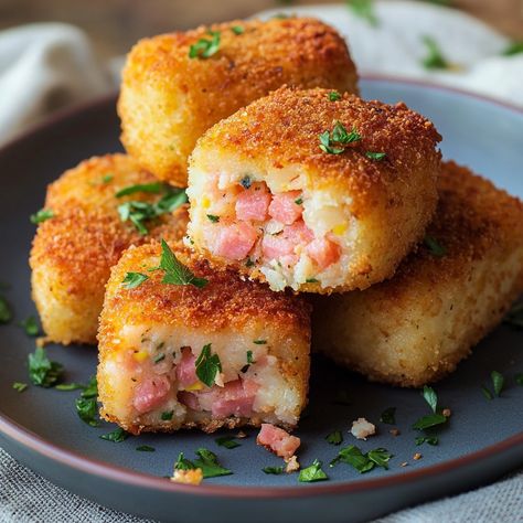 🥔🥓 Recipe: Ham and Potato Croquettes 🥓🥔 Ingredients: 500g potatoes 150g diced ham 1 egg 100g grated cheese 50g flour Breadcrumbs Salt and pepper Oil for frying Instructions: Cook the potatoes in water until tender. Drain and mash them. In a bowl, mix the mashed potatoes, ham, cheese, egg, flour, salt and pepper. Form small balls or croquettes with the mixture. Roll each croquette in breadcrumbs. Heat the oil in a frying pan and simmer the croquettes until golden on each side. Drain on abso... Ham And Potato Croquettes, Ham Croquettes, Potato Rolls Recipe, Fried Ham, Mashed Potato Balls, Cheese Mashed Potatoes, Potato Croquettes, Potato Roll, Ham Cheese