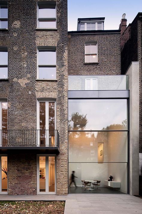 House on Bassett Road is a contemporary renovation and remodeling of a Victorian town house in Kensington, West London by Paul+O Architects. The project incorporates a double-height glazed extension to the rear featuring a unique motorized sash-window. Extension Inspiration, Glass Extension, Glass Walls, Design Exterior, Architecture Exterior, House Extensions, Architectural Inspiration, Residential Architecture, Apartment Building