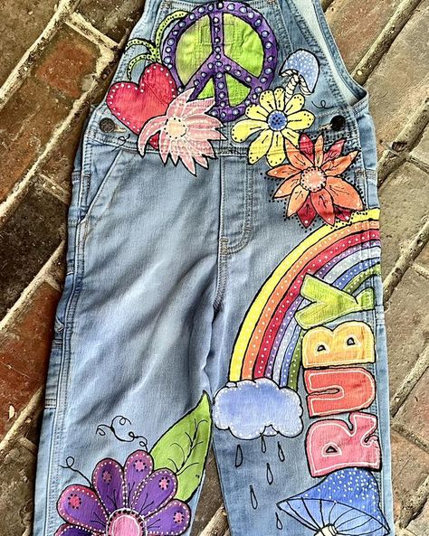 Been busy. I want to get all my orders finished before the 15th. Here is a new painted overalls design for a new customer in Rhode Island! #artistsofinstagram #painted #painted #overalls #paintedoveralls #painted #denim #painteddenim #painteddenimjeans #kids #kidsfashion #boutique #boutiqueshopping #boutiquestyle #boutiquefashion #boutiqueclothing #kidsboutique #kidsboutiqueclothing #kidsboutiques #kidsboutiqueuagirl #hippy #hippylife #hippystyle #hippychick #hippyvibes #hippyart #hippylove ... Painting On Denim, Custom Overalls, Flowers And Rainbows, Painted Overalls, Bohemian Studio, Long Overalls, Toddler Birthday Party, Girls Overalls, Hippie Girl