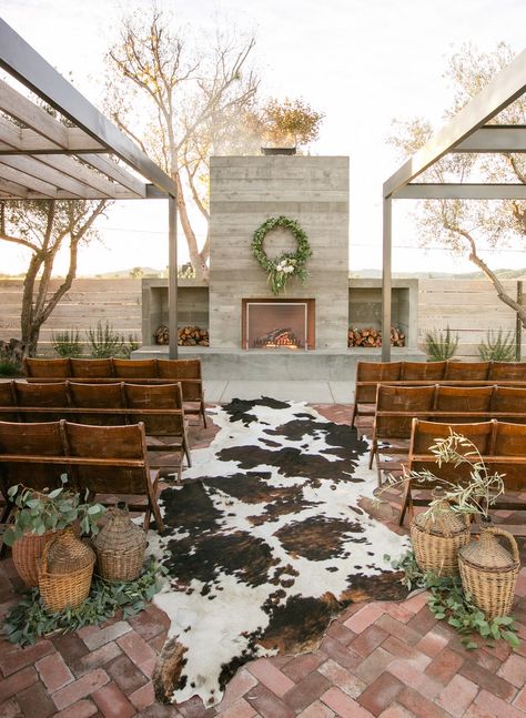 With a faux cow skin rug as an aisle centerpiece, wicker basket ceremony markers, and fireplace altar, this ranch style wedding is cozy and inviting, perfecting Southwestern charm. Ranch Style Weddings, Cowboy Wedding, Boda Mexicana, Future Wedding Plans, Rustic Chic Wedding, Venue Ideas, Western Wedding, Ranch Wedding, Ranch Style