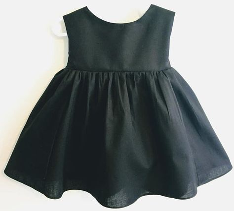 The perfect little black dress for babies or toddlers! This soft woven cotton dress features a lined bodice, snap closures in the back and an attached sash at the waist that tie into a pretty little bow in the back. **beads are not included in dress purchase and are for display Designer Net Frocks For Kids, Baby Girl Frock Designs Cotton, Girl Frock Design Cotton, Toddler Pageant Dress, Toddler Black Dress, Long Frocks For Kids, Long Frocks For Girls, Black Dress Simple